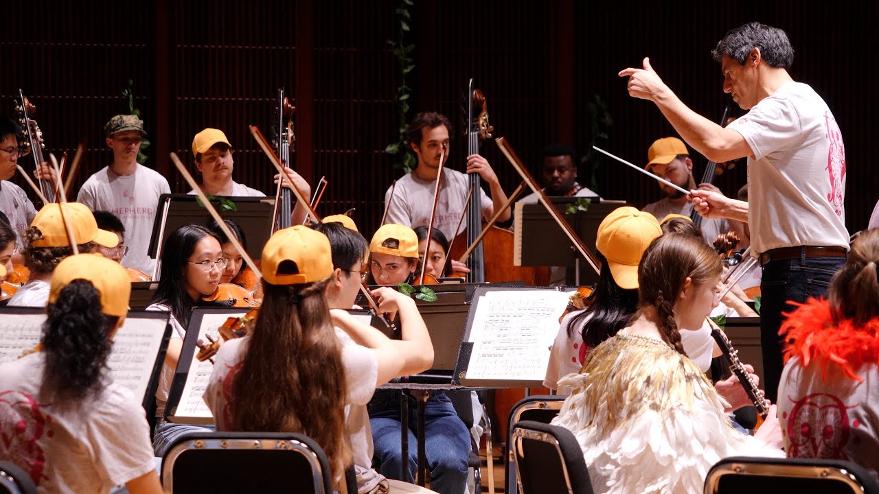 String orchestra in rehearsal with conductor